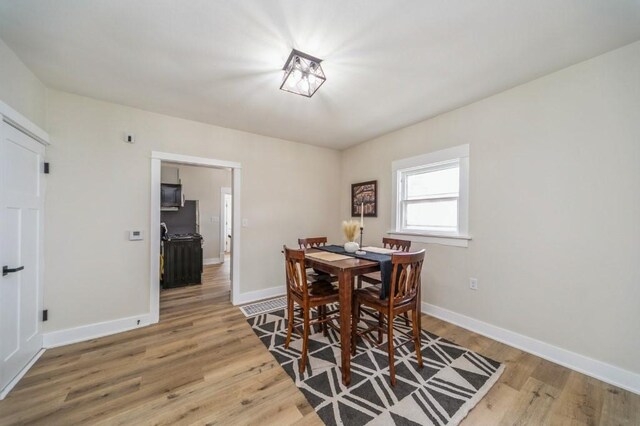 212 Nile Kinnick Dr N, Adel, IA 50003 - dining space with wood finished floors and baseboards