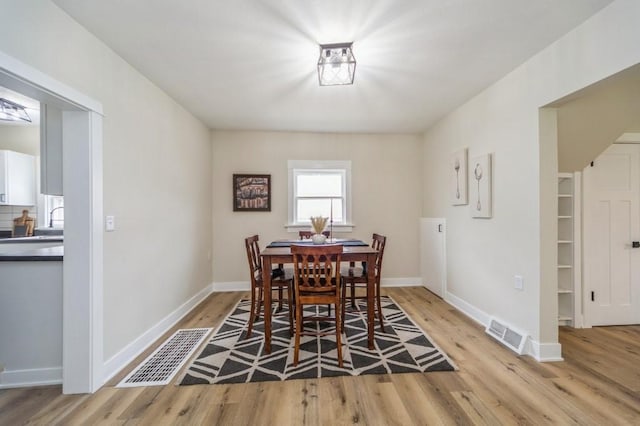 212 Nile Kinnick Dr N, Adel, IA 50003 - dining space featuring light wood-type flooring and baseboards