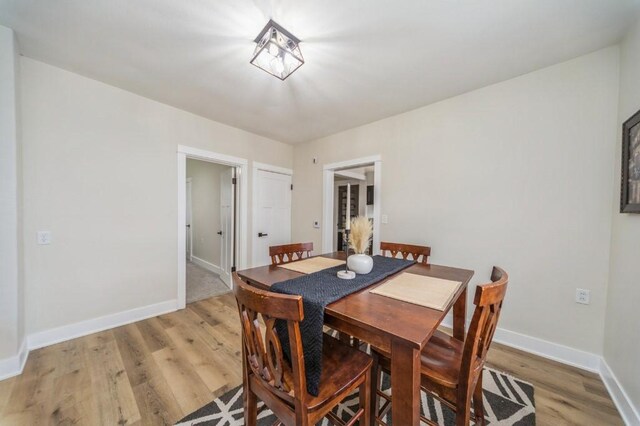 212 Nile Kinnick Dr N, Adel, IA 50003 - dining area with light wood-type flooring and baseboards