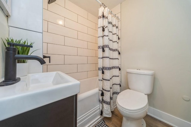 212 Nile Kinnick Dr N, Adel, IA 50003 - full bath featuring wood finished floors, baseboards, shower / bath combination with curtain, toilet, and a sink