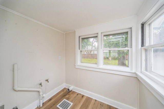 212 Nile Kinnick Dr N, Adel, IA 50003 - empty room with baseboards, light wood finished floors, and ornamental molding