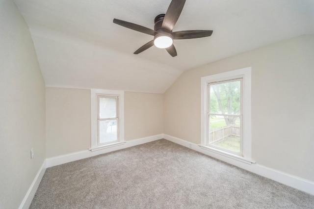 212 Nile Kinnick Dr N, Adel, IA 50003 - additional living space with vaulted ceiling, carpet, a ceiling fan, and baseboards