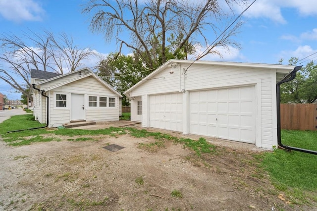 212 Nile Kinnick Dr N, Adel, IA 50003 - view of front of home featuring a detached garage, an outbuilding, and entry steps