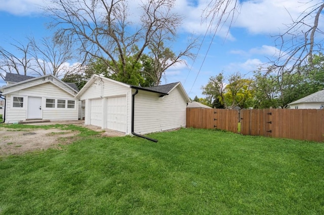 212 Nile Kinnick Dr N, Adel, IA 50003 - view of yard featuring a detached garage, an outbuilding, and a gate