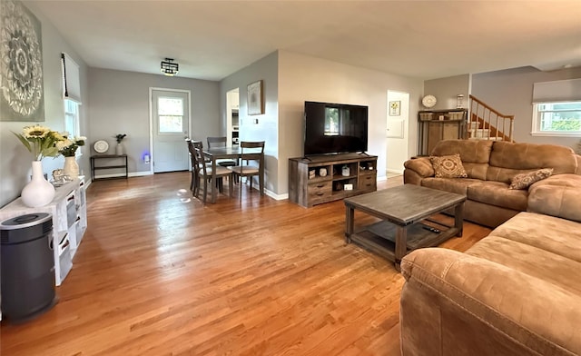 1541 42nd St, Des Moines, IA 50311 - living area with light wood finished floors and stairway