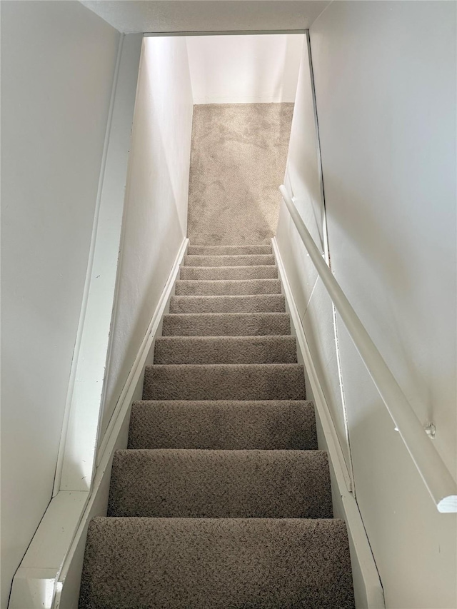 1541 42nd St, Des Moines, IA 50311 - stairway featuring carpet flooring