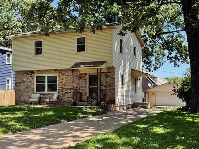 1541 42nd St, Des Moines, IA 50311 - view of front of property featuring brick siding, a garage, and an outbuilding