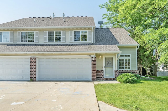 5221 Village Run Ave Unit 402, Des Moines, IA 50317 - view of front facade with brick siding, concrete driveway, a front yard, a garage, and a shingled roof