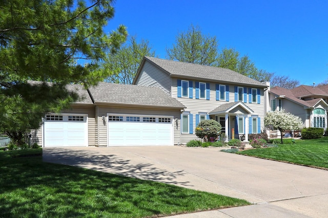 5909 Brookview Dr, West Des Moines, IA 50266 - colonial home featuring driveway, an attached garage, and a front yard