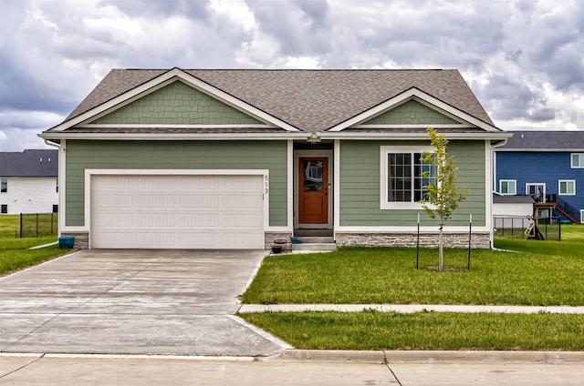 513 Walnut Dr, Huxley, IA 50124 - craftsman-style house with driveway, a front lawn, a garage, and a shingled roof