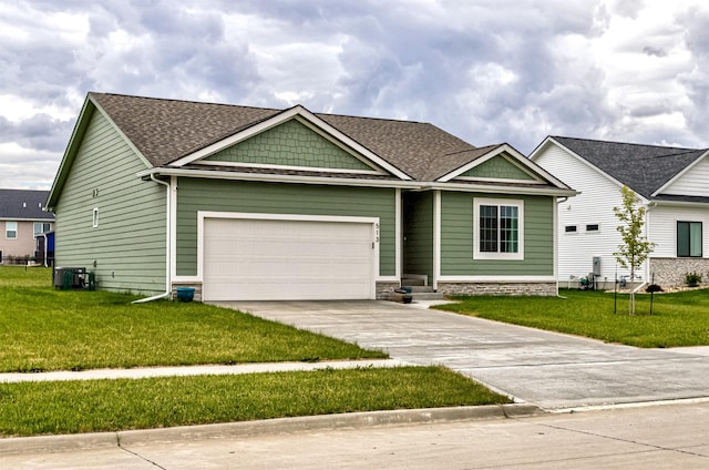 513 Walnut Dr, Huxley, IA 50124 - craftsman-style house featuring concrete driveway, a front lawn, a garage, cooling unit, and a shingled roof