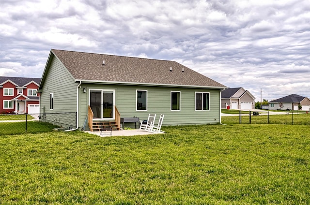 513 Walnut Dr, Huxley, IA 50124 - back of property featuring entry steps, a patio area, and a shingled roof