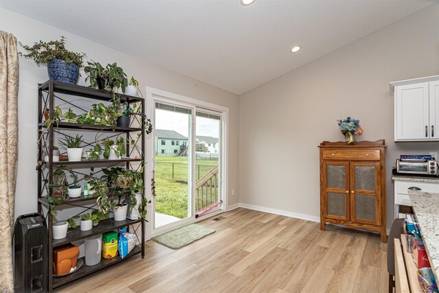 513 Walnut Dr, Huxley, IA 50124 - entryway featuring lofted ceiling, light wood finished floors, recessed lighting, and baseboards