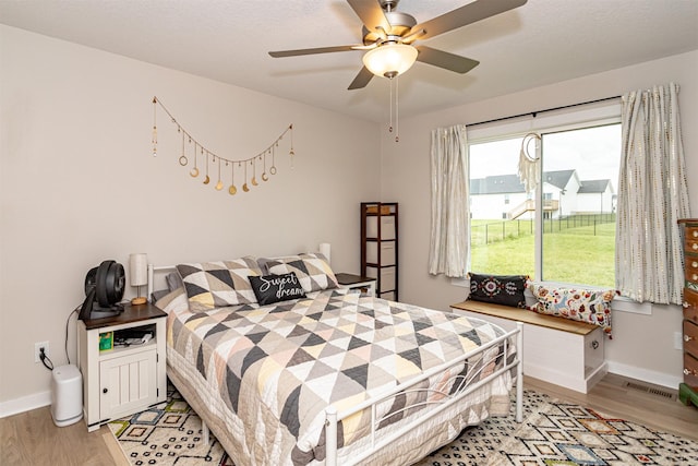 513 Walnut Dr, Huxley, IA 50124 - bedroom with light wood-style flooring, baseboards, and a ceiling fan