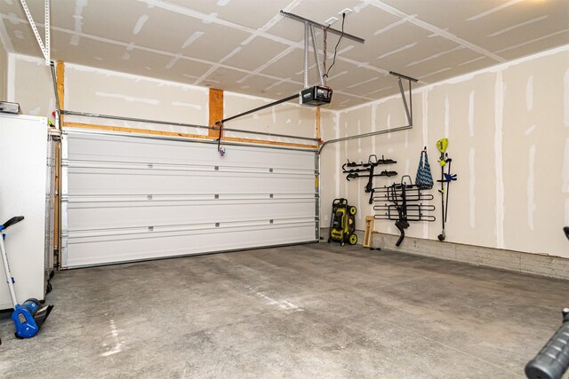 513 Walnut Dr, Huxley, IA 50124 - garage with a garage door opener