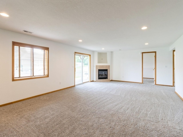 5213 SE 30th St, Des Moines, IA 50320 - unfurnished living room featuring light colored carpet, baseboards, recessed lighting, and a tile fireplace