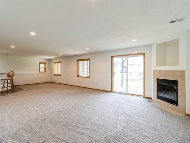 5213 SE 30th St, Des Moines, IA 50320 - unfurnished living room featuring recessed lighting, carpet flooring, a tile fireplace, and baseboards