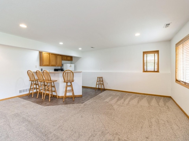 5213 SE 30th St, Des Moines, IA 50320 - carpeted dining space featuring baseboards, recessed lighting, and bar