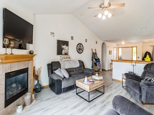 5213 SE 30th St, Des Moines, IA 50320 - living room with arched walkways, wood finished floors, lofted ceiling, ceiling fan, and a fireplace