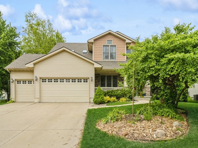 6818 Jules Verne Ct, Johnston, IA 50131 - view of front of house featuring an attached garage, driveway, a shingled roof, covered porch, and a front yard