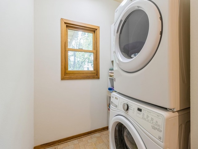 6818 Jules Verne Ct, Johnston, IA 50131 - washroom featuring stacked washer and clothes dryer and baseboards
