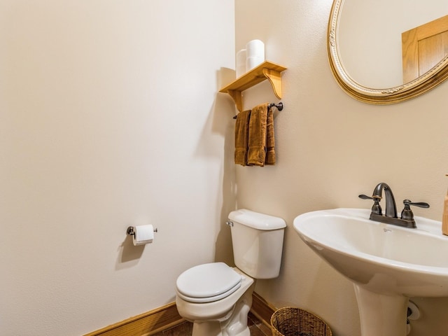 6818 Jules Verne Ct, Johnston, IA 50131 - bathroom with toilet, a sink, and baseboards