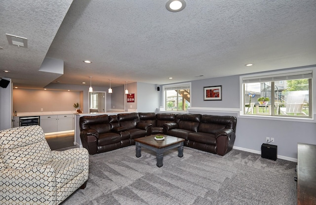 1880 Brodie St, Waukee, IA 50263 - living area with a textured ceiling, beverage cooler, carpet floors, recessed lighting, and bar
