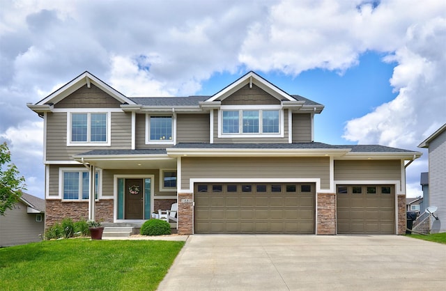1880 Brodie St, Waukee, IA 50263 - craftsman-style house featuring driveway, a garage, a front yard, and stone siding