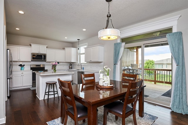 1880 Brodie St, Waukee, IA 50263 - dining room with dark wood-style flooring, recessed lighting, and a textured ceiling