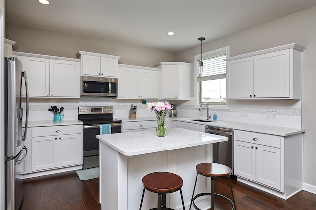 1880 Brodie St, Waukee, IA 50263 - kitchen featuring appliances with stainless steel finishes, a sink, backsplash, dark wood finished floors, and recessed lighting
