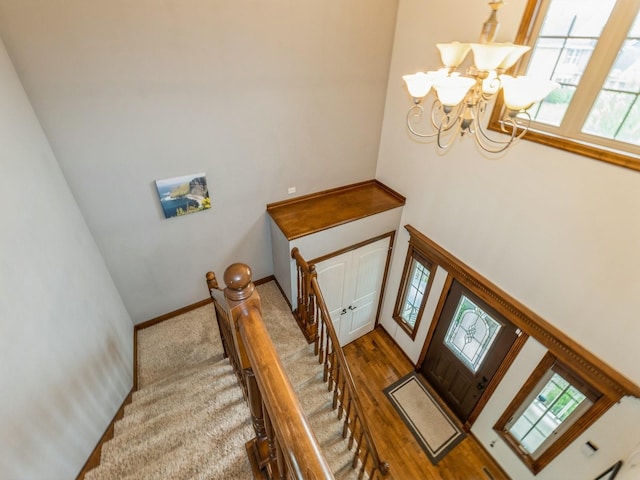 8305 Century Dr, West Des Moines, IA 50266 - stairs with a chandelier and a towering ceiling
