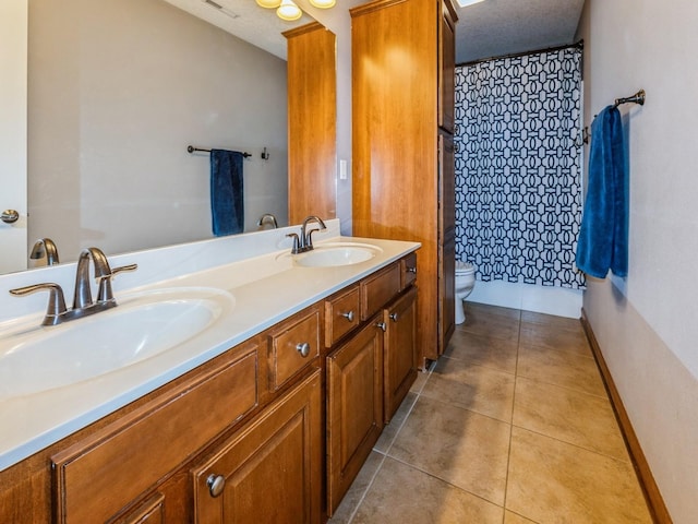 8305 Century Dr, West Des Moines, IA 50266 - bathroom with double vanity, tile patterned floors, and curtained shower