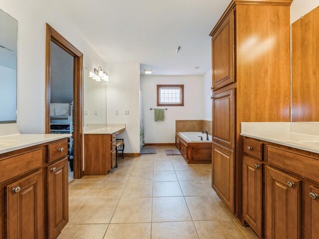 8305 Century Dr, West Des Moines, IA 50266 - bathroom with two vanities, a bath, and tile patterned floors