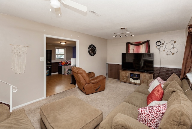 4006 67th St, Urbandale, IA 50322 - carpeted living room featuring ceiling fan and baseboards