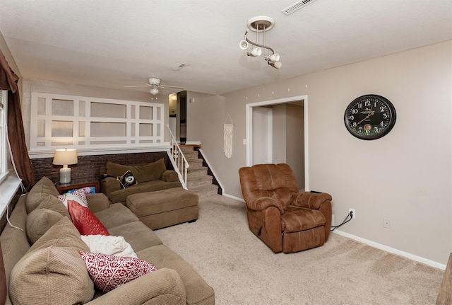 4006 67th St, Urbandale, IA 50322 - living room featuring carpet flooring, baseboards, ceiling fan, and stairs