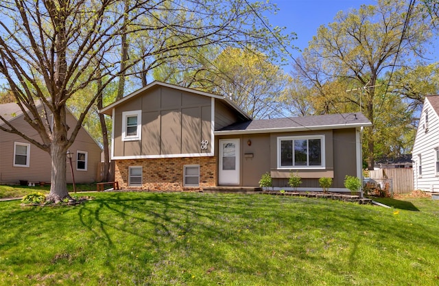 4006 67th St, Urbandale, IA 50322 - split level home featuring brick siding, a front yard, and a shingled roof