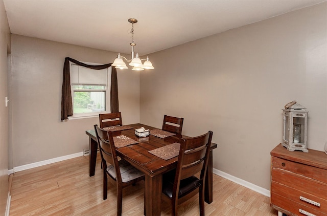 4006 67th St, Urbandale, IA 50322 - dining space featuring light wood-style floors, a chandelier, and baseboards