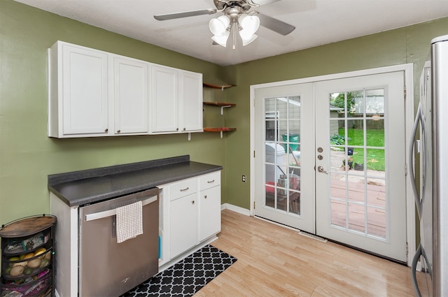 4006 67th St, Urbandale, IA 50322 - kitchen with french doors, stainless steel appliances, dark countertops, white cabinetry, and light wood-style floors