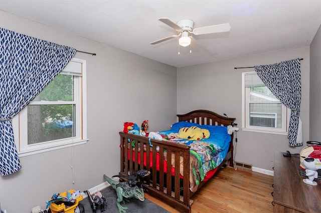 4006 67th St, Urbandale, IA 50322 - bedroom with wood finished floors, baseboards, and ceiling fan