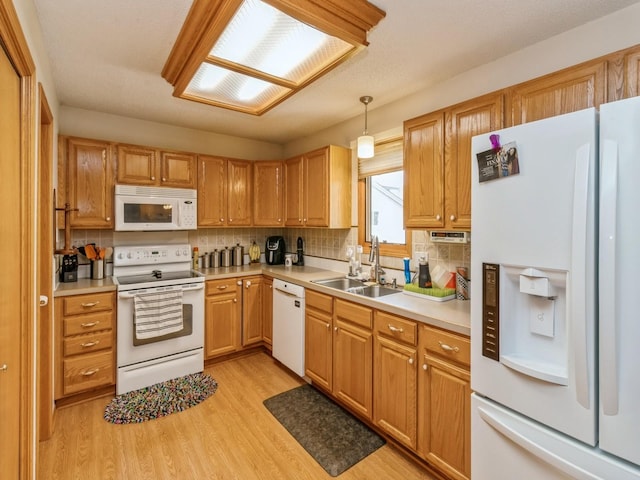1506 W 17th St S, Newton, IA 50208 - kitchen with white appliances, a sink, backsplash, light wood finished floors, and light countertops