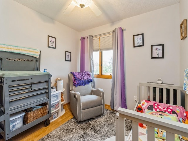 1506 W 17th St S, Newton, IA 50208 - bedroom featuring wood finished floors, a ceiling fan, and baseboards