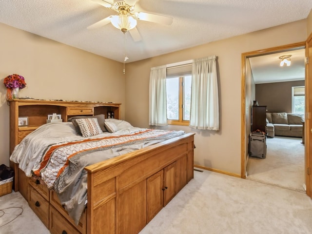 1506 W 17th St S, Newton, IA 50208 - bedroom featuring light colored carpet, baseboards, a ceiling fan, and a textured ceiling