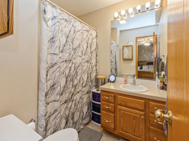1506 W 17th St S, Newton, IA 50208 - bathroom with toilet, vanity, curtained shower, and tile patterned floors