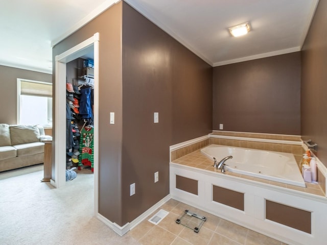 1506 W 17th St S, Newton, IA 50208 - full bathroom with a jetted tub, ornamental molding, baseboards, tile patterned floors, and a walk in closet