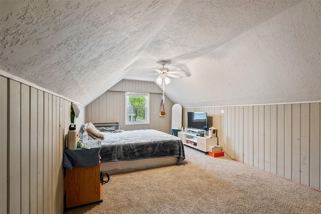 1452 55th St, Des Moines, IA 50311 - bedroom with lofted ceiling, a textured ceiling, carpet floors, ceiling fan, and wooden walls