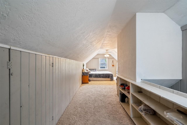 1452 55th St, Des Moines, IA 50311 - carpeted bedroom with lofted ceiling and a textured ceiling
