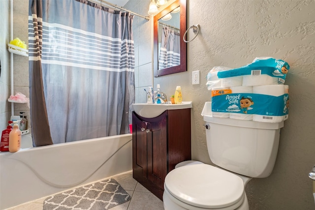 1452 55th St, Des Moines, IA 50311 - full bathroom featuring vanity, shower / tub combo with curtain, tile patterned floors, toilet, and a textured wall