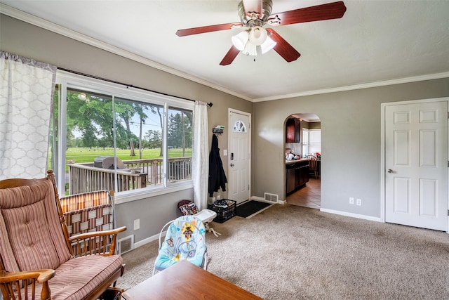 1452 55th St, Des Moines, IA 50311 - sitting room featuring arched walkways, baseboards, carpet, a ceiling fan, and crown molding