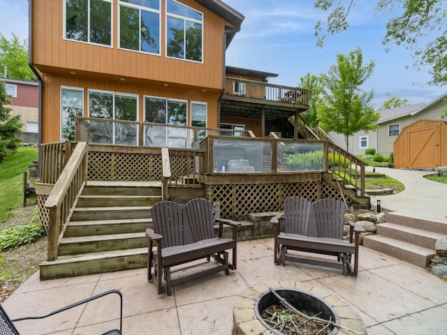 201 Cottage Ln, Montezuma, IA 50171 - view of patio featuring stairs, a fire pit, and a deck