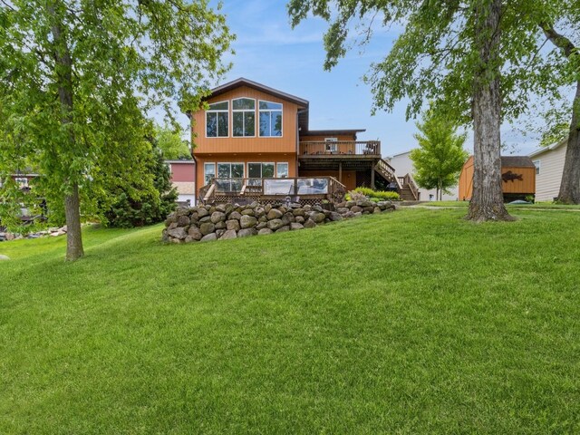 201 Cottage Ln, Montezuma, IA 50171 - back of house featuring a wooden deck, stairs, and a yard
